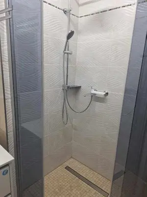 a shower with a glass door in a bathroom at Rent Olamit in Karkazai