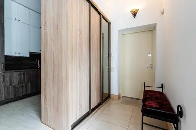 a room with a wooden partition with a bench in it at Gusto Apartment in Kaunas