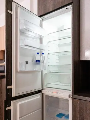an empty refrigerator with its door open in a kitchen at Gusto Apartment in Kaunas