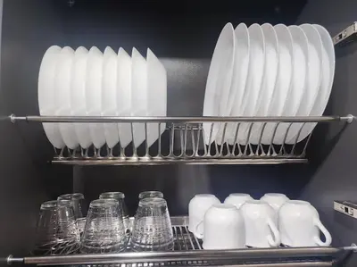a shelf filled with white vases and glass jars at Kaunas Castle Apartment in Kaunas