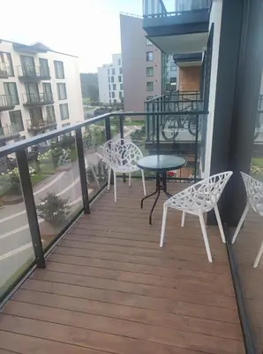 a balcony with a table and chairs on a building at Kaunas Castle Apartment in Kaunas