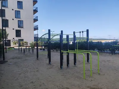 an empty playground in a park next to a building at Kaunas Castle Apartment in Kaunas