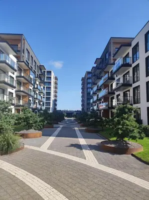 an empty street in a city with tall buildings at Kaunas Castle Apartment in Kaunas