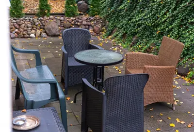 a group of chairs and a table and a table and chairs at Elegant Old Town Apartment with Terrace & Parking in Vilnius