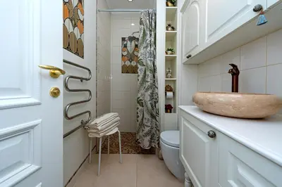 a bathroom with a sink and a toilet at Elegant Old Town Apartment with Terrace & Parking in Vilnius