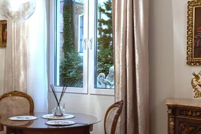 a dining room with a table and a window at Elegant Old Town Apartment with Terrace & Parking in Vilnius