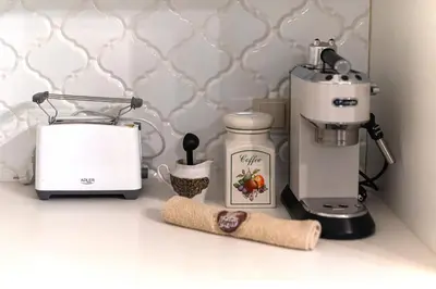 a kitchen counter with a coffee maker and a blender at Elegant Old Town Apartment with Terrace & Parking in Vilnius