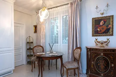 a dining room with a table and chairs and a window at Elegant Old Town Apartment with Terrace & Parking in Vilnius