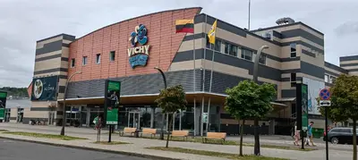 a building with a sign on the side of it at Ozas Park Apartments in Vilnius