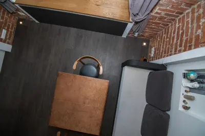 a kitchen with a kettle on the wall next to a refrigerator at Modernios klasikos studija in Kaunas
