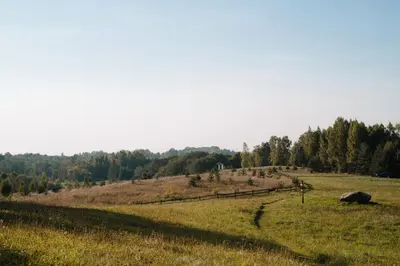 a field with a fence in the middle of it at Terra Gratia - namukas Išminčius in Nemeikšiai