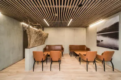 a meeting room with leather chairs and a table at Zaliakalnio Terasos apartamentai 2 in Kaunas