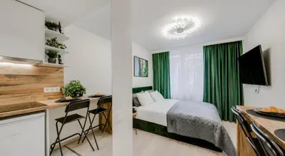 a bedroom with a bed and a desk in a room at Zveryno apartment in Vilnius