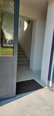 a hallway of a building with a door with a mat at Platforma2b in Šiauliai