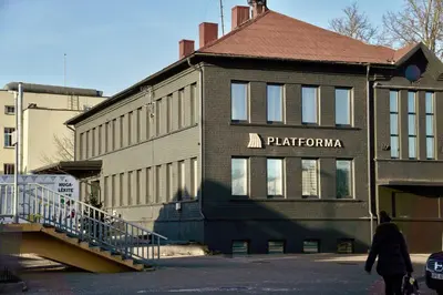 a building with a sign on the side of it at Platforma2b in Šiauliai