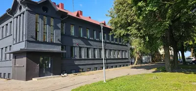 a black building with a pole in front of it at Platforma2b in Šiauliai