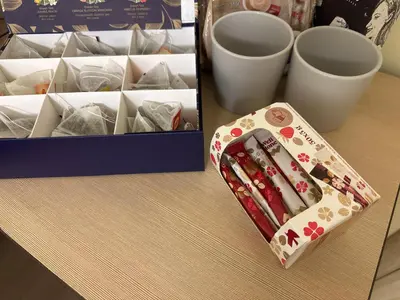 a box of chopsticks sitting on a table next to cups at A5 apartment in Vilnius