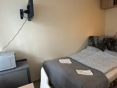 a bedroom with a bed with two towels on it at A5 apartment in Vilnius