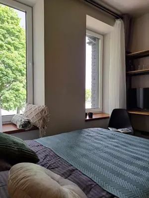 a bedroom with a large bed and a window at Platforma2b eco in Šiauliai