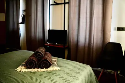 a pile of towels sitting on top of a bed at Platforma2b eco in Šiauliai