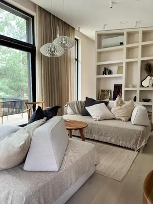 a living room with two beds and a table at IVIS House Lakeside Retreat in Vilnius in Vilnius