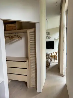 a room with a closet and a bedroom at IVIS House Lakeside Retreat in Vilnius in Vilnius
