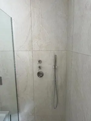 a shower with a glass door with a shower head at IVIS House Lakeside Retreat in Vilnius in Vilnius