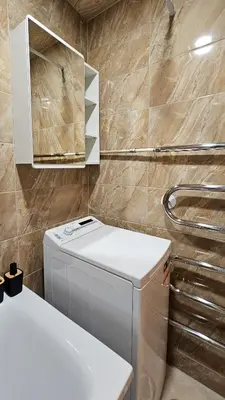 a small bathroom with a toilet and a sink at SunCity Apartment in Šiauliai