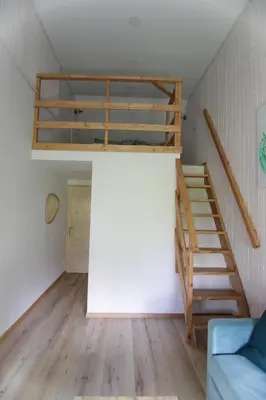 a room with a loft bed and a couch at Vila Pakaso malūnas in Kirdeikiai