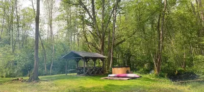a gazebo in the middle of a forest at Vila Pakaso malūnas in Kirdeikiai