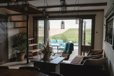 a living room with a couch and a table at LAGUNA SPA šeimos poilsio namai in Geniai