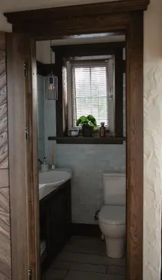 a bathroom with a toilet and a sink and a window at LAGUNA SPA šeimos poilsio namai in Geniai