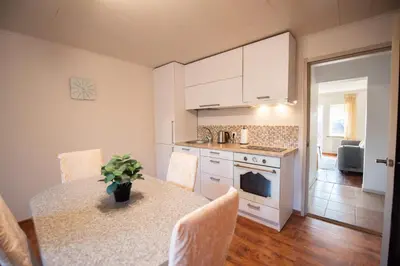 a kitchen with a table and a kitchen with a stove at Angelica Apartment in Vilnius