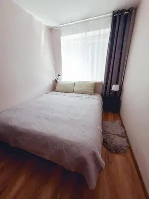 a small bedroom with a bed and a window at Šiauliai Central Cozy Apartment in Šiauliai