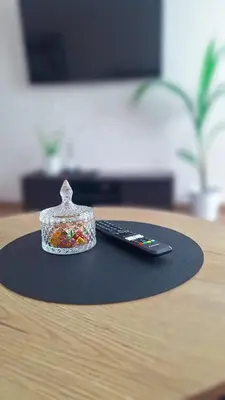 a remote control sitting on top of a table at Šiauliai Central Cozy Apartment in Šiauliai