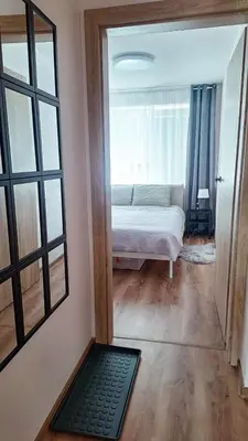 a bedroom with a bed and a large window at Šiauliai Central Cozy Apartment in Šiauliai
