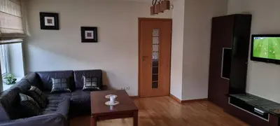 a living room with a couch and a flat screen tv at city center apartment in Panevėžys