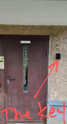 a door with red writing in front of it at city center apartment in Panevėžys