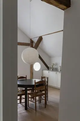 a dining room with a table and chairs at Aštriosios Kirsnos dvaras in Aštrioji Kirsna