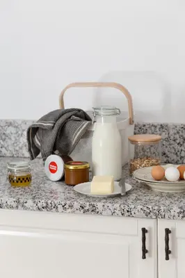 a counter with eggs milk and other ingredients on it at Aštriosios Kirsnos dvaras in Aštrioji Kirsna