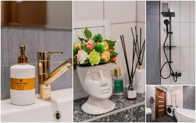 a bathroom with a sink with a vase with flowers in it at ASTeS Apartments in Šiauliai