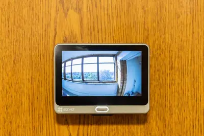 a cell phone sitting on top of a wooden table at ASTeS Apartments in Šiauliai