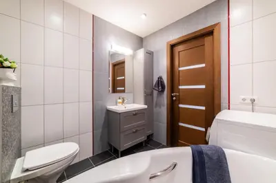 a bathroom with a toilet and a sink and a tub at ASTeS Apartments in Šiauliai
