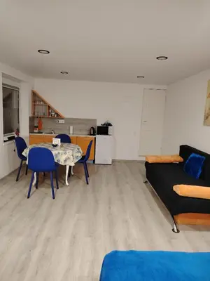 a living room with a table and a couch at Jolsva in Rokiškis