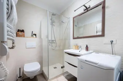 a bathroom with a toilet and a sink and a shower at Butukas dviems in Vilnius