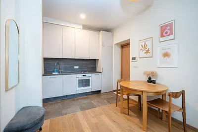 a kitchen and dining room with a table and chairs at Butukas dviems in Vilnius