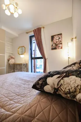 a bedroom with a large bed with a window at Stunning new flat in Old Town of Vilnius in Vilnius