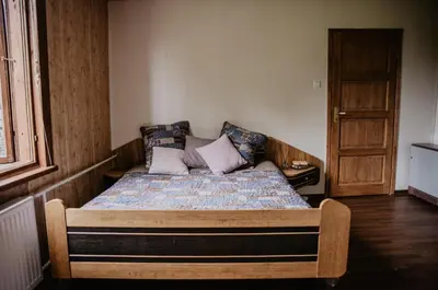 a bedroom with a bed with a wooden frame at Hillas in Tauragnai