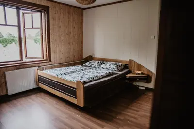 a bedroom with a bed in a room with a window at Hillas in Tauragnai