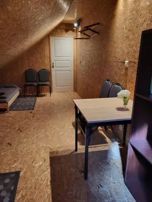 a room with a table and chairs and a door at Hillas in Tauragnai